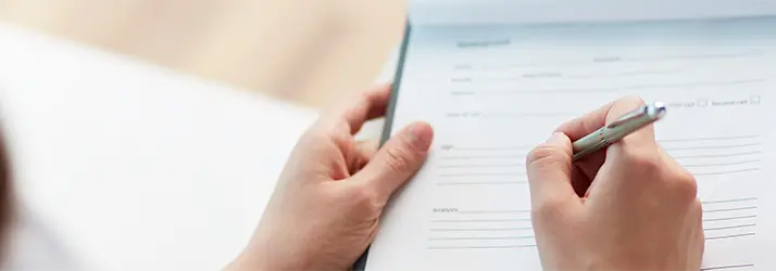 A person filling out paperwork.